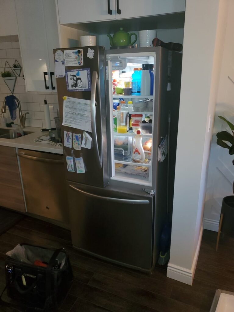 Fix4U Repairs workers are working on this refrigerator.