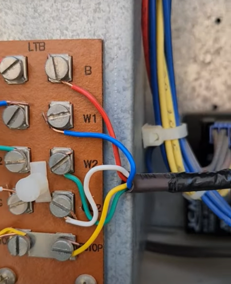 Fix4U Repairs' technicians fixing ac thermostat wiring problem in GTA  